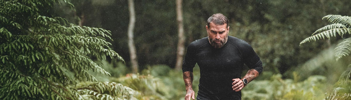 Ant Middleton, Team NORTH Adventurer, runs through a forest