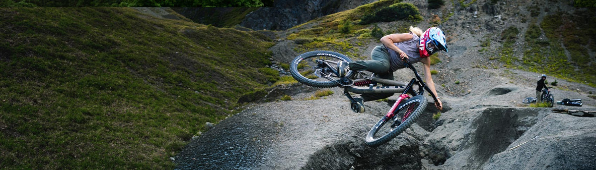 Casey Brown, Team NORTH Athlete, performs a jump on her mountain bike