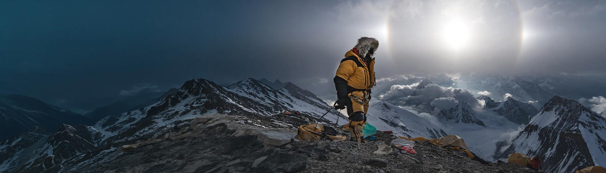 Renan Ozturk, Team NORTH Adventurer and Photographer, at base camp atop a tall mountain