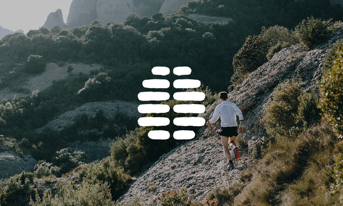 Photo of a person jogging on rugged mountain terrain. There is an icon on top of the image.