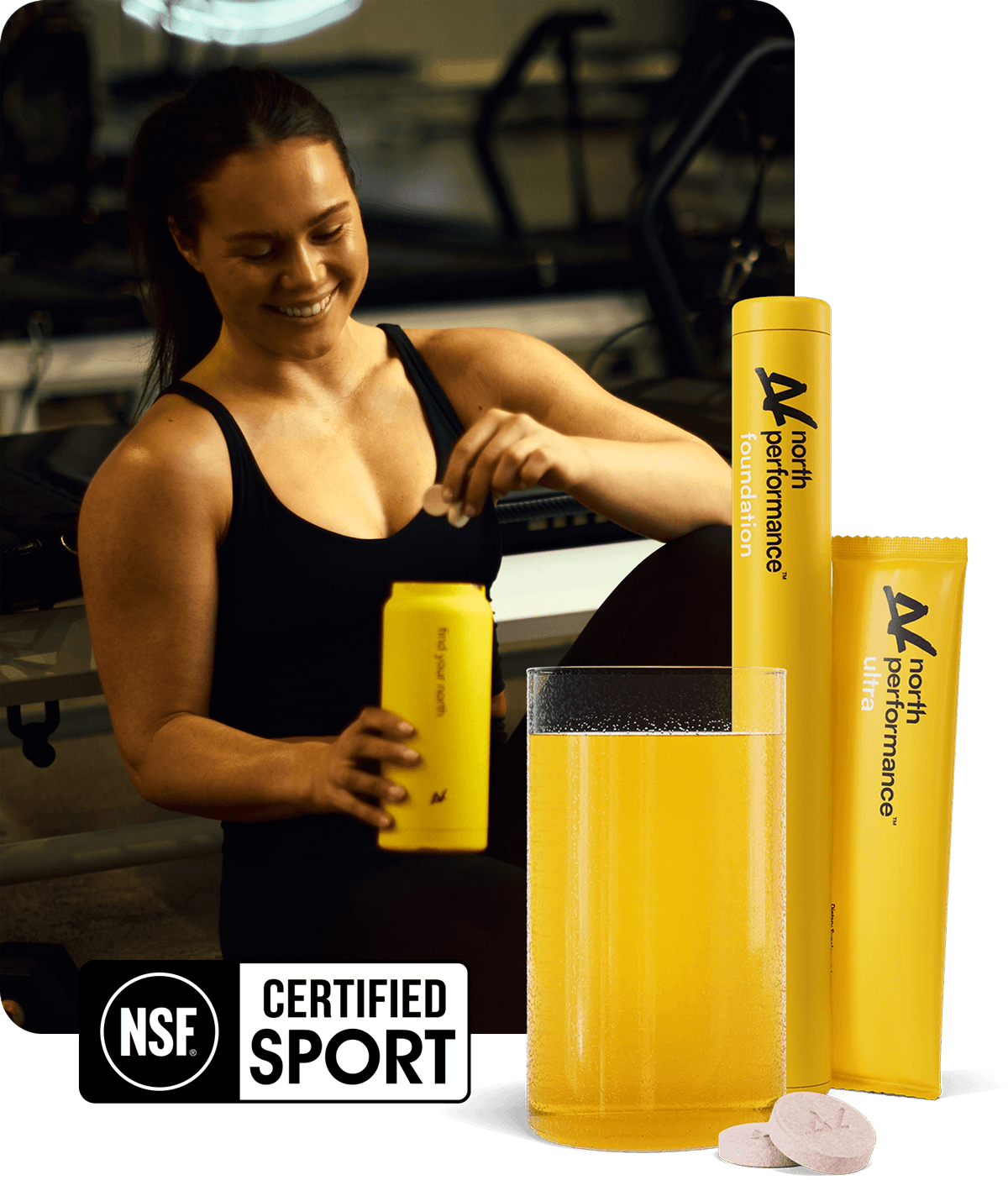 A woman in a gym setting is shown holding a yellow NORTH drink bottle, with the NORTH product packaging displayed in the foreground: a tall yellow NORTH Foudnation tube and a clear glass filled with yellow liquid, plus two NORTH Foundation effervescent tablets. There is a NORTH Ultra product sachet in the background.